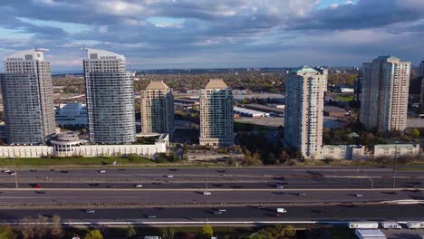 Residential-growth-and-development-along-Highway-401-in-Toronto,-Ontario,-Canada-showing-heavy-traffic-during-rush-hour-commute