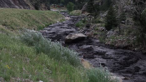 Der-Big-Thompson-River-Läuft-Während-Einer-Schlammlawine-In-Der-Nähe-Von-Glen-Haven,-Colorado,-Nach-Einem-Plötzlichen-Sommersturm-Schwarz-Von-Schlamm-Und-Asche