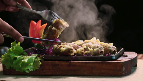 Close-Up-Roasted-Chicken-BBQ-Kebab-With-Knife-Cutting-Black-Background