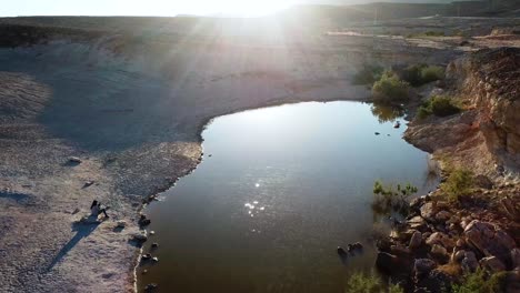 Aerial-shot-along-lake-in-desert-surroundings