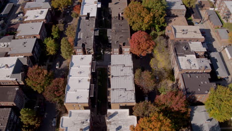 Aerial-over-a-historic-neighborhood-in-the-fall-with-a-tilt-up-to-reveal-a-seminary-in-the-park-and-city-skyline