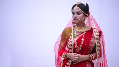 Sad-and-unhappy-Indian-Bengali-bride-against-a-white-wall