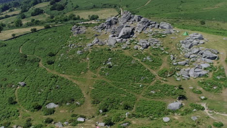 Wide-shot-aerial-tracking-forward-over-Bonehill-Rocks,-Dartmoor,-Devon,-England