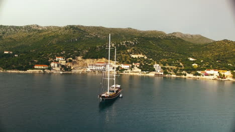 Aerial-circle-shot-around-a-sailboat-in-a-little-Croatian-lake
