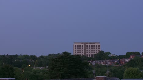 Dawn-and-dusk-timelapse-lasting-for-1-minute-of-a-large-office-building-in-a-suburban-area-of-England