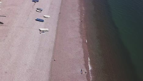 Aerial-view-of-an-almost-empty-beach-in-Budleigh-Salterton,-East-Devon,-England