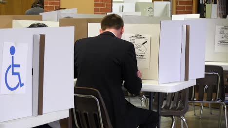 Back-of-head-of-man-casting-political-election-vote-wearing-a-suit
