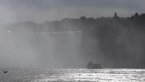 Birds-flying-in-slow-motion-infront-of-niagra-falls-with-boat-,-canada