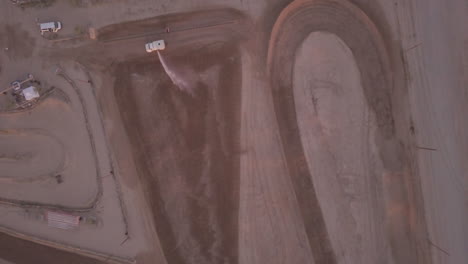 Truck-watering-dirt-race-track,-Aerial-View
