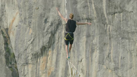 Athlete-on-high-line-slack-line-over-cliff-in-Germany