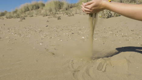 Sand-falling-through-a-womans-hand