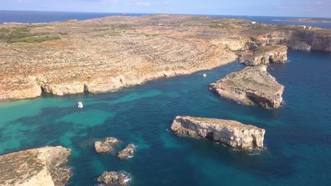 Wide-aerial-view-of-dive-boats-anchored-in-the-clear-warm-water-off-the-coast-of-Malta
