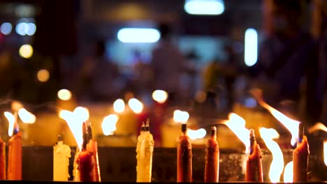 A-sliding-shot-of-candles-at-a-chinese-temple