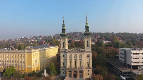 Aerial-shot-of-a-chatolic-church,-as-camera-flying-through-the-bell-towers