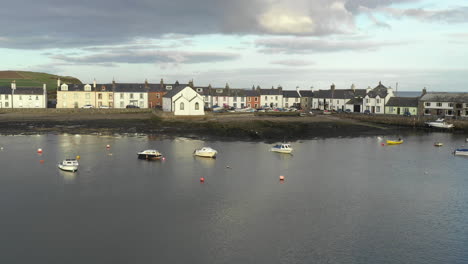 A-view-of-the-small-Scottish-village-of-Isle-of-Whithorn-in-Dumfries-and-Galloway-with-small-boats-anchored-in-the-harbour
