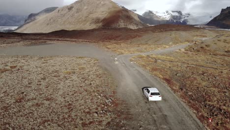 Tight-Aerial-Follow-Shot-of-a-Car-Driving-Towards-a-Glacier