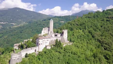 Aerial-view-of-Castel-Telvana-in-Borgo-Valsugana,-Trentino,-Italy-with-drone-flying-forward-on-a-very-clear-day