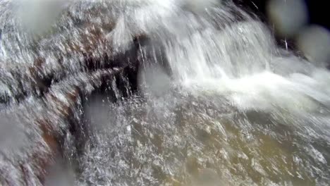 Water-running-over-rocks-and-splashing-the-camera-lens