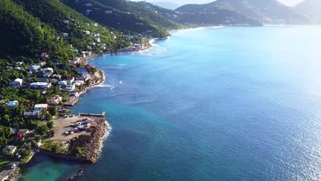 Aerial-British-Virgin-Island-Tortola-beach-fly-by-of-local-homes-on-the-water-angle-2