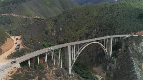 Aerial-Drone-Stock-Video-of-Bixby-Bridge-Highway-with-water-and-shore-below-in-Big-Sur-Monterrey-California