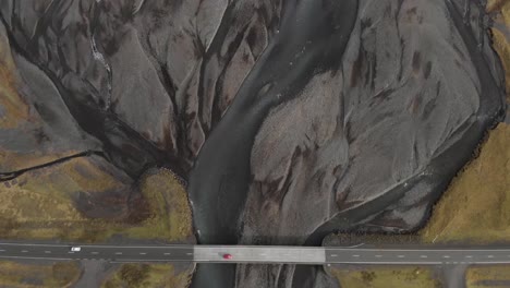Aerial-shot-of-a-road-crossing-glacial-river-system