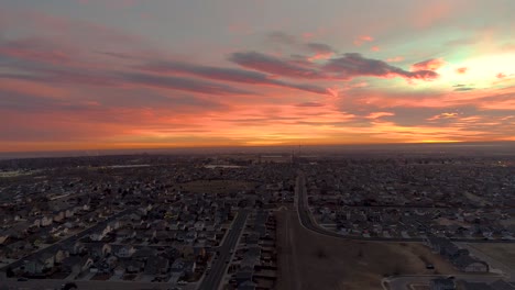 A-drone-flies-forward-over-an-epic-urban-sunrise-in-Northern-Colorado
