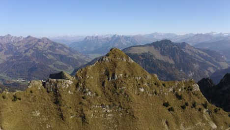 Aerial-orbit-of-prealpine-summit-"La-Cape-au-Moine",-Vaud---Switzerland-Autumn-colors-and-the-Alps-in-the-background