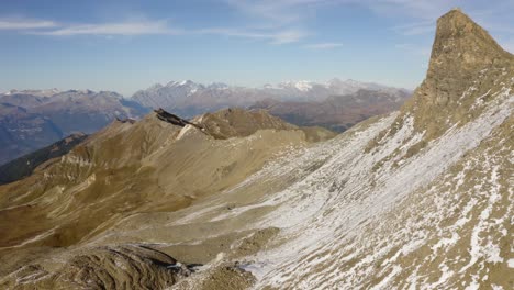 Aerial-climbing-along-rocky-summit,-revealing-Alpine-landscape-"Becs-de-Bosson",-Valais---Switzerland