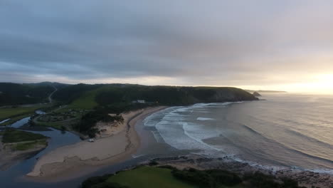 Cinematic-aerial-flying-at-sunrise-over-East-London-South-Africa-coast