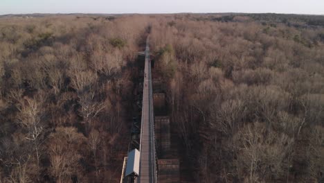 A-dramatic-orbital-shot-over-High-Bridge-Trail,-a-reconstructed-Civil-War-era-railroad-bridge-in-Virginia,-revealing-the-bridge,-Appomattox-River-beneath-and-surrounding-valley