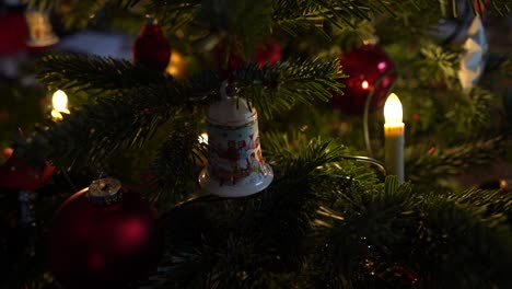 close-shot-of-bell-in-a-christmas-tree-with-christmas-lights