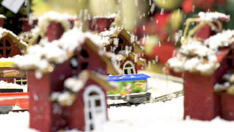 Cute-toy-city-with-train-moving-under-snow