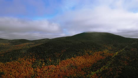 Aerial-footage-pulling-back-from-mountain-in-peak-autumn-colors