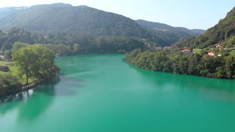 Aerial-video-of-lake-at-Most-na-Soci,-Slovenia