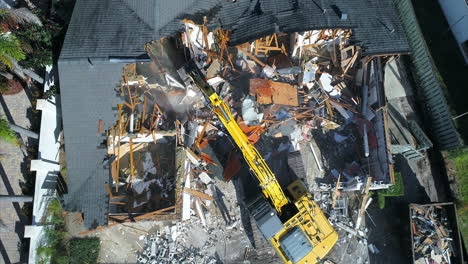 Top-down-view-of-a-house-demolition-with-an-excavator