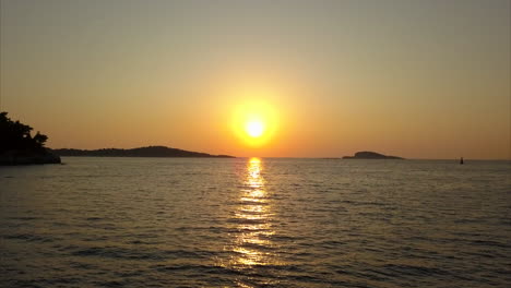 Orange-Sunset-out-to-sea-with-silhouettes-of-islands-in-the-distance-filmed-in-Croatia,-Dubrovnik
