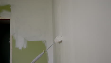 Person-Paints-A-Wall-White-Using-A-Paint-Roller