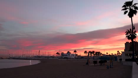 Sunset-over-the-beach-and-harbor-of-Fuengirola,-Malaga,-Spain