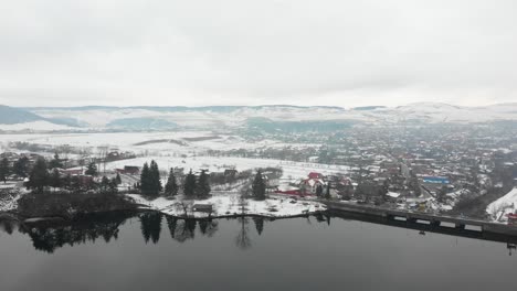 Aerial-view-over-a-snowy-dam-in-Romania