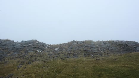 Edge-of-Flat-Rocky-Cliff-Side-Overlooking-Cloud-of-Fog