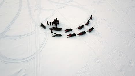 Drone-view-of-ice-fishing-in-Saariselka,-Lapland,-Finland