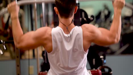 Rear-extreme-closeup-of-young-bodybuilder-doing-lat-pulldowns-on-a-machine