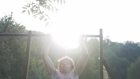 Young-man-explosive-clap-pull-ups-fitness-outdoor-home-gym-workout