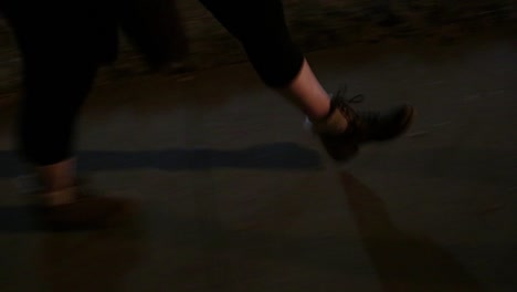 Feet-of-women-wearing-leggings-waking-along-sidewalk-high-angle-close-up