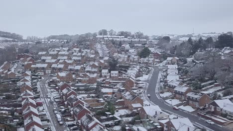 High-sideways-tracking-drone-shot-of-snowy-Exeter-subburbs-CROP