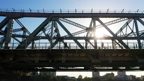Two-runners-and-a-walker-on-a-large-bridge-'Story-Bridge'-in-Brisbane-Australia