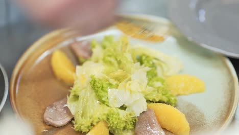 Process-of-making-fresh-green-salad-with-slices-of-meat-and-potatoes