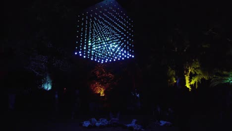 People-lying-under-of-a-cube-of-hanging-lights