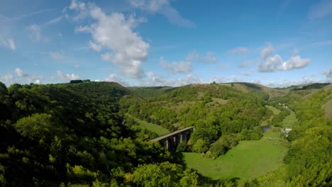 Aerial-view,-footage-of-Headstone-Viaduct-in-Bakewell,-Derbyshire,-the-Peak-District-National-Park,-on-a-beautiful-cloud-filled-Summers-day,-commonly-used-by-cyclists,-hikers,-popular-with-tourists