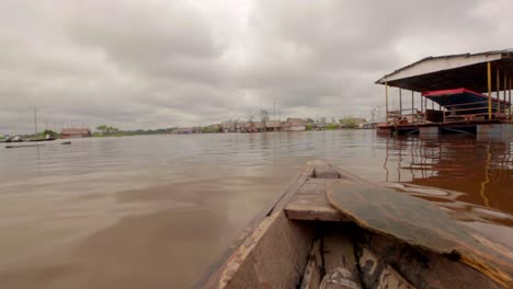 Small-boats-transporting-through-a-village-in-Iquitos,-Peru-on-the-Amazon-River
